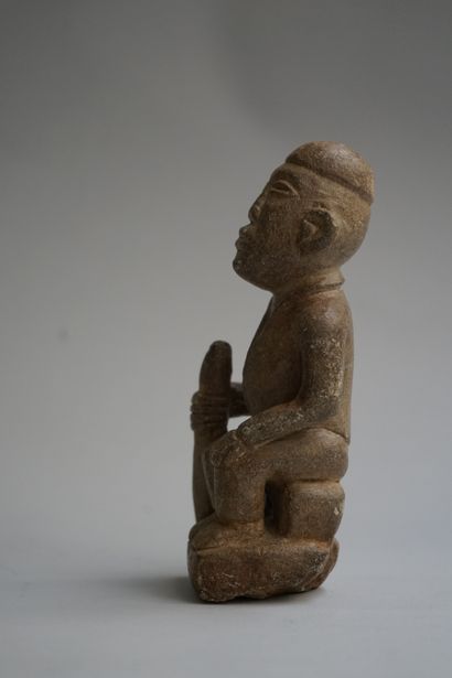 Figure showing a seated chief holding a stick....