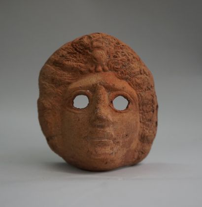 Diminutive mask in pink clay. Greco-Roman...