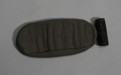 Small cylinder seal in black stone showing...