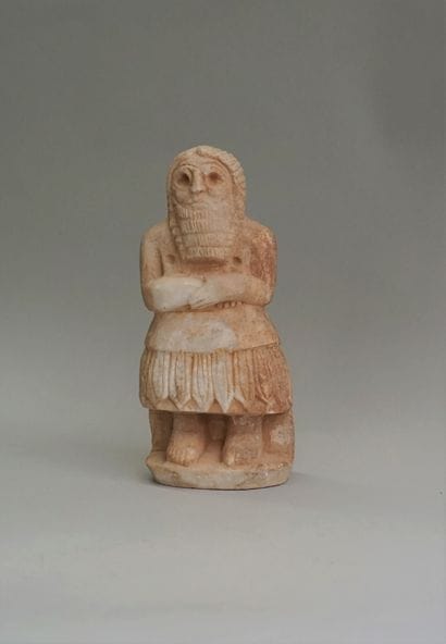Statuette of a priest in stone (alabaster?),...