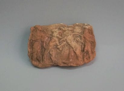 Terracotta plate decorated with slaves and...
