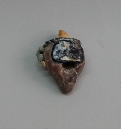 Amulet bead in polychrome glass paste representing...