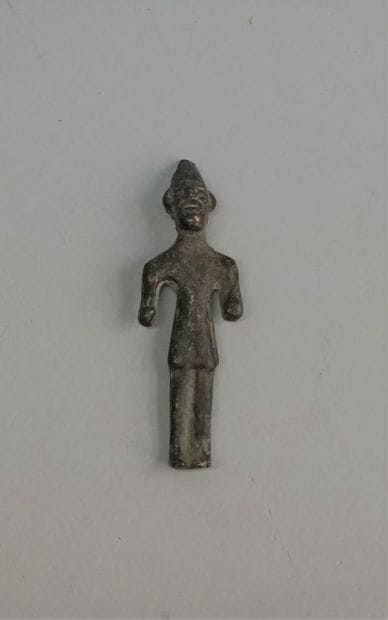 Idol in bronze with green patina representing...