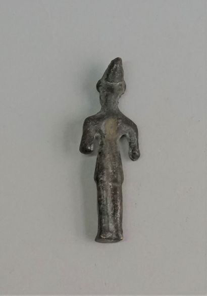 Idol in bronze with green patina representing...