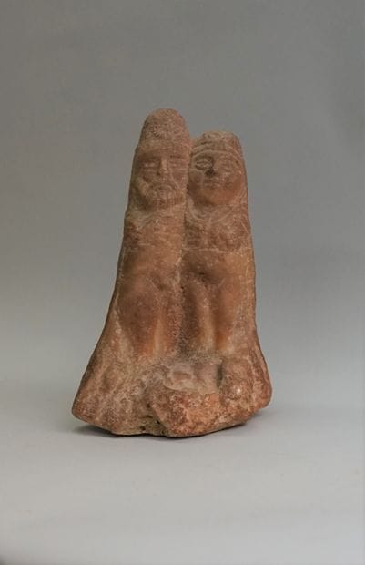 Couple embracing in beige orangy stone in...