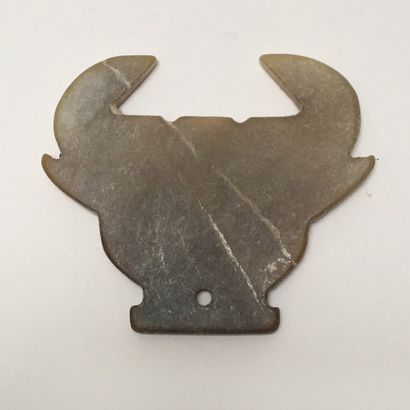 Very stylized brown/yellow jade bovine head....