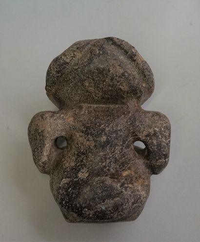 Idol with stylized features in black volcanic...