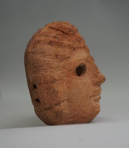 Diminutive mask in pink clay. Greco-Roman...
