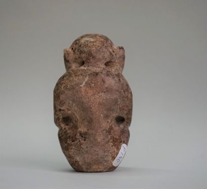 Idol with stylized features in black volcanic...