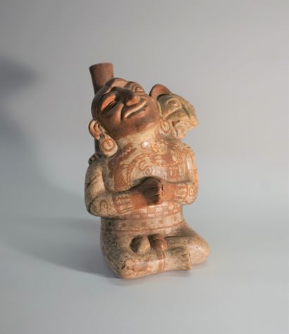 Beige and red ceramic stirrup vase representing...