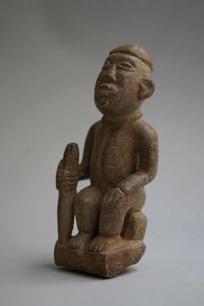 Figure showing a seated chief holding a stick....