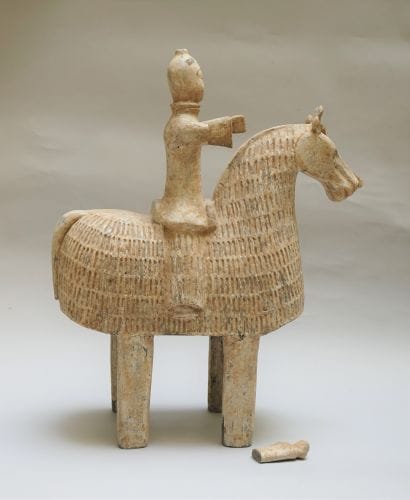 Warrior on a caparisoned horse. Beige and...