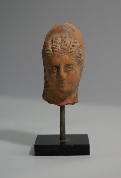 Terracotta head with earthy patina presenting...