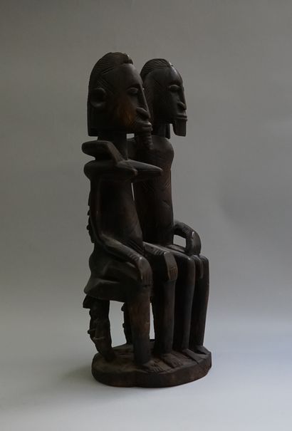 Anthropomorphic statue of a couple sitting...