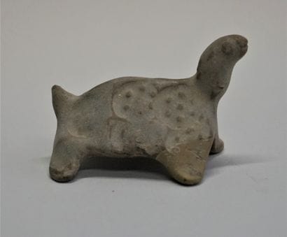 Small turtle in orange clay. One front leg...