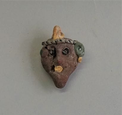 Amulet bead in polychrome glass paste representing...