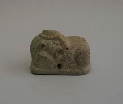 Small curved caprid in greenish brown stone....