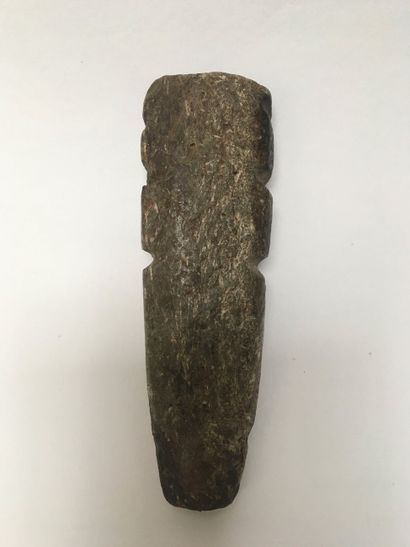 Monolithic figure standing in dark green...