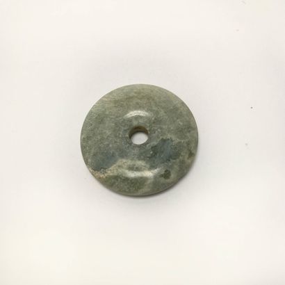 Green translucent chalcedony disc.

Undetermined...