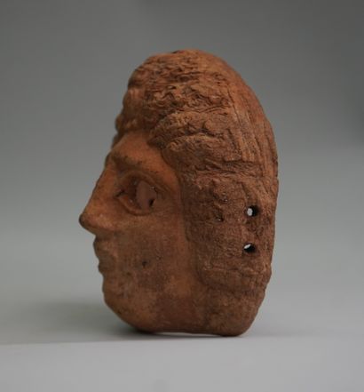 Diminutive mask in pink clay. Greco-Roman...