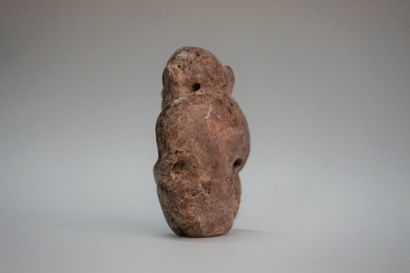 Idol with stylized features in black volcanic...