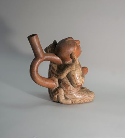 Beige and red ceramic stirrup vase representing...