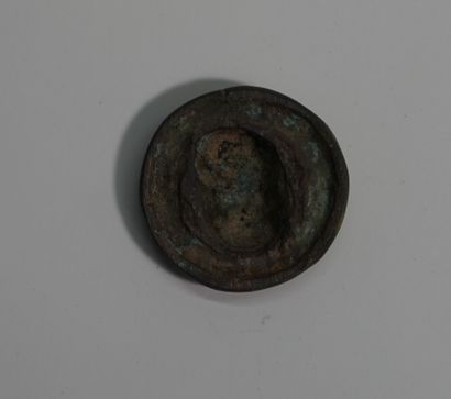 Small bronze token with brown and oxidized...