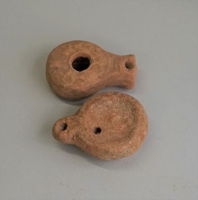 2 pinkish beige terracotta oil lamps with...