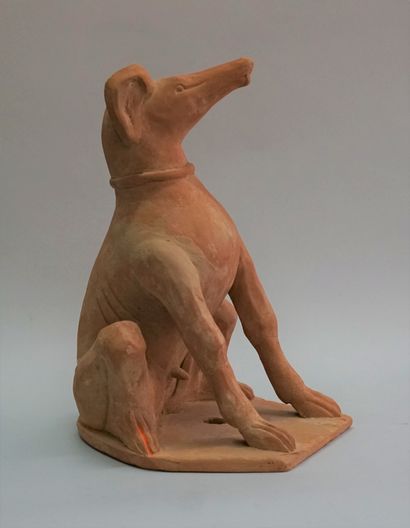 Statue of a sitting greyhound. Orange terracotta....
