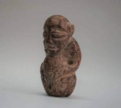 Idol with stylized features in black volcanic...