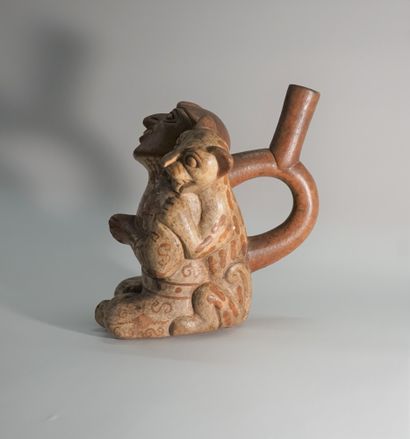 Beige and red ceramic stirrup vase representing...