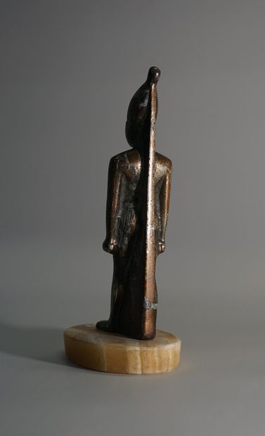 Egyptian statuette of a deity in regula with...