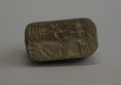 Small curved caprid in greenish brown stone....