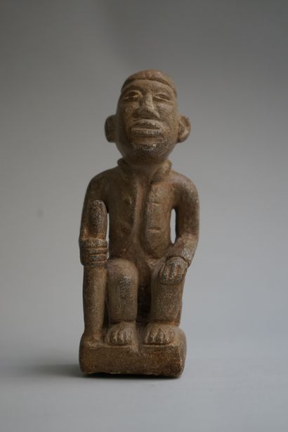 Figure showing a seated chief holding a stick....
