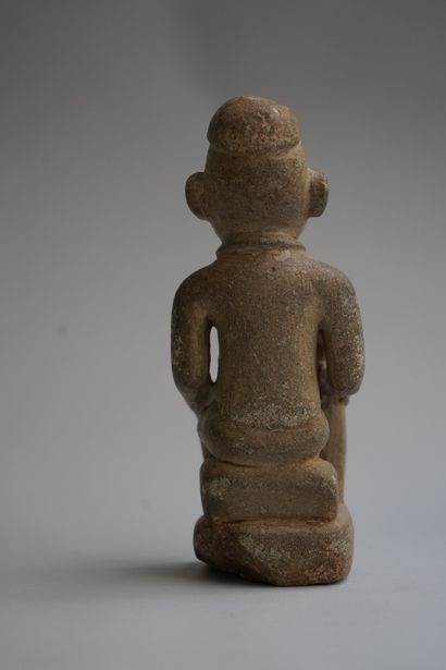 Figure showing a seated chief holding a stick....