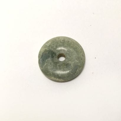 Green translucent chalcedony disc.

Undetermined...
