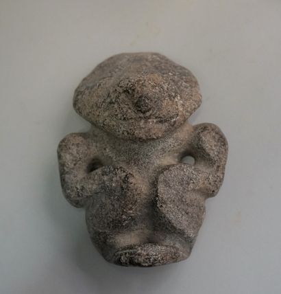 Idol with stylized features in black volcanic...