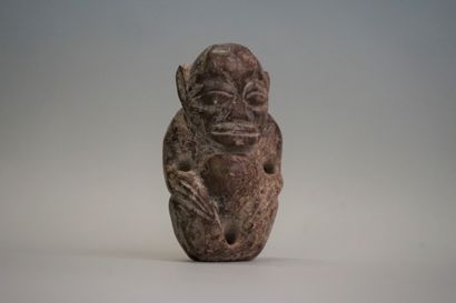 Idol with stylized features in black volcanic...