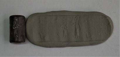 Black stone cylinder seal with inscriptions...