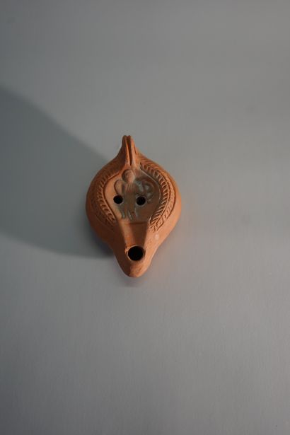 Orange terracotta oil lamp, decorated with...