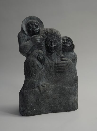 Group in black hardstone presenting an elderly...