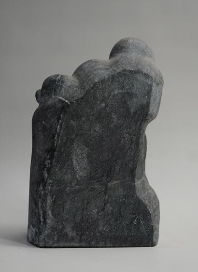 Group in black hardstone presenting an elderly...