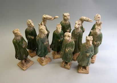 Twelve figures of a procession with heads...