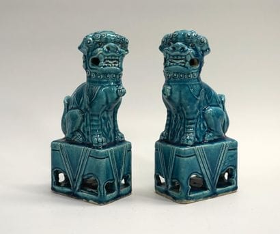 Pair of lions in turquoise porcelain, sitting...