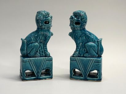 Pair of lions in turquoise porcelain, sitting...