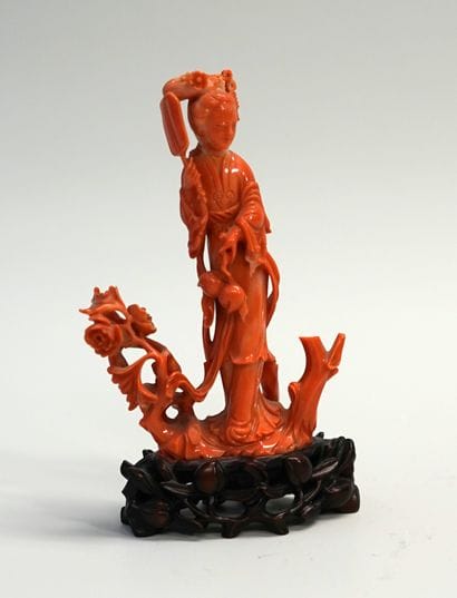 Young woman with a fan in orange red coral....