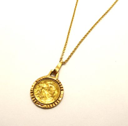 CHAIN and MEDAL in 18K (750/°°) yellow gold...