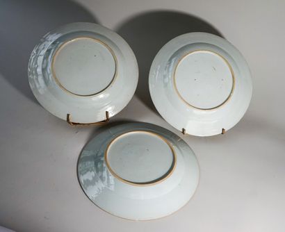 Nine white porcelain plates with polychrome...