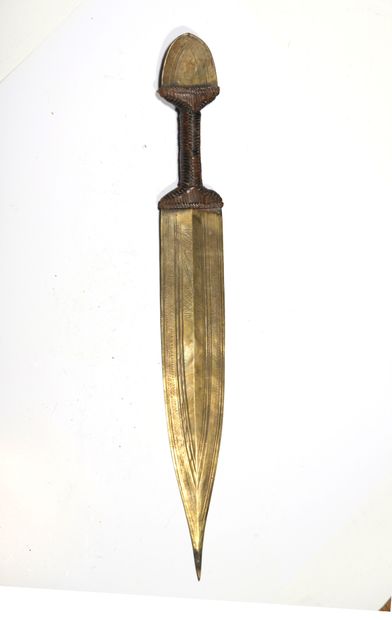 Small knife with a ribbed brass blade and...