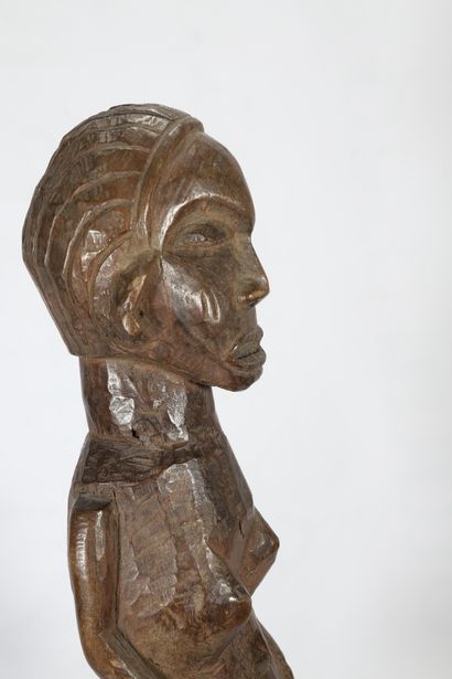 Statue féminine en bois présentée debout,...
